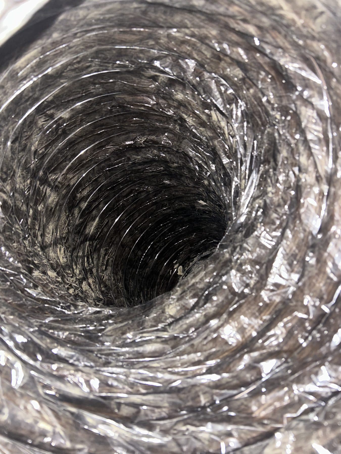 The same flexible duct interior cleaned back to bare foil liner